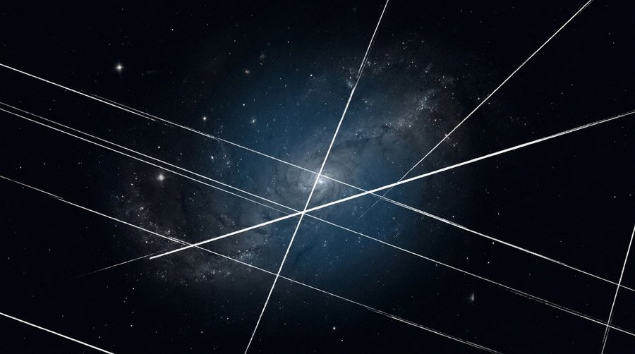 Astrophotography image of a galaxy completely crossed by multiple bright parallel satellite streaks