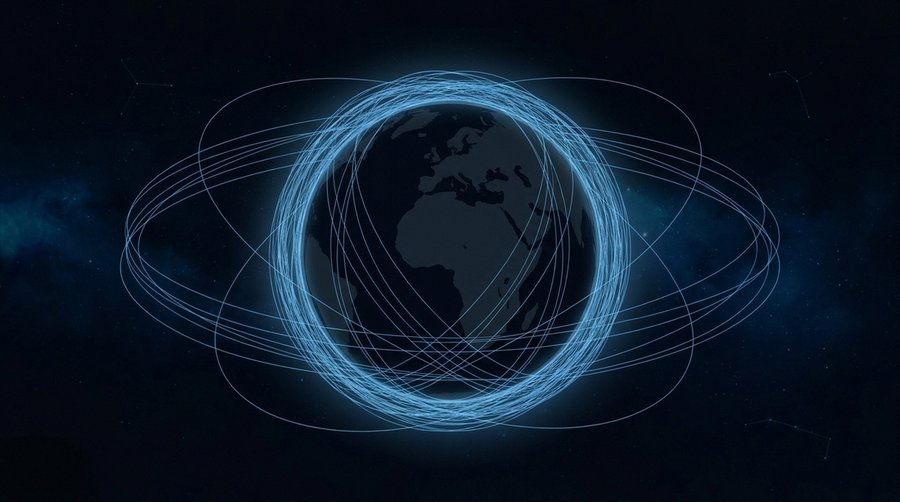 Earth globe from space surrounded by a dense shell of satellite orbits shown as fine glowing lines